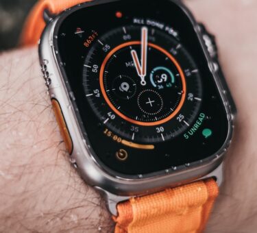 Apple Watch Ultra worn on a wrist showing its rugged dive-style bezel, illustrating the apple watch ultra 2 vs 3 comparison