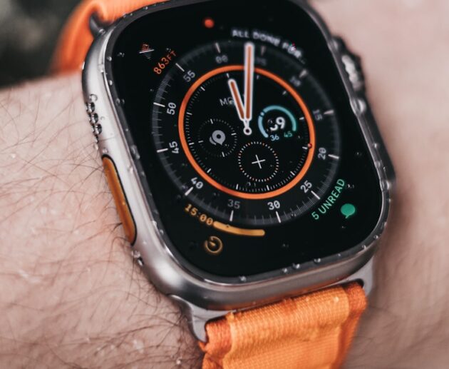 Apple Watch Ultra worn on a wrist showing its rugged dive-style bezel, illustrating the apple watch ultra 2 vs 3 comparison