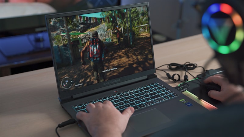 Gaming laptop keyboard and screen during play, where sustained cooling decides real frame rates
