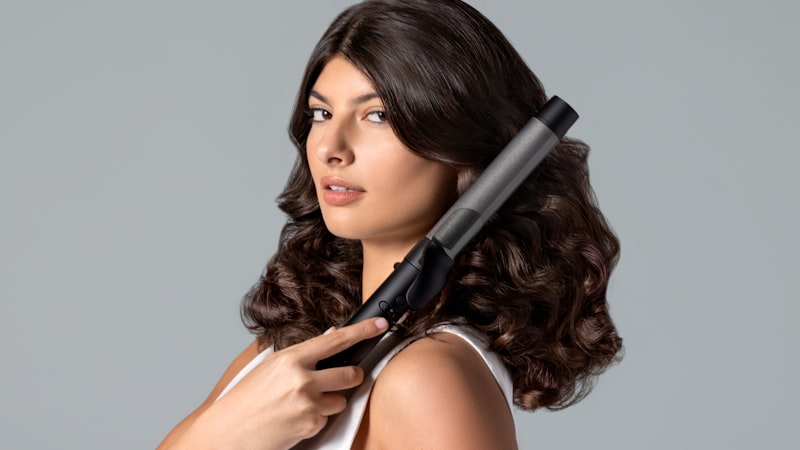Heated styling tool used on thick wavy hair, the hair type that needs a brush straightener with higher heat