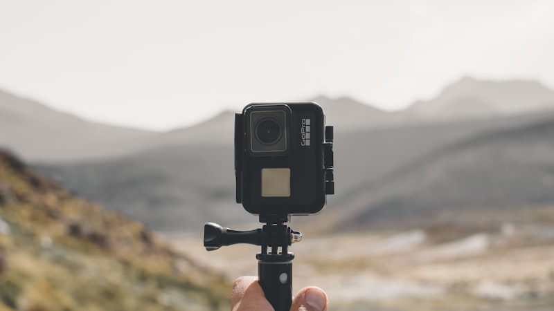 Waterproof action camera mounted on a grip pole outdoors, where stabilization matters most