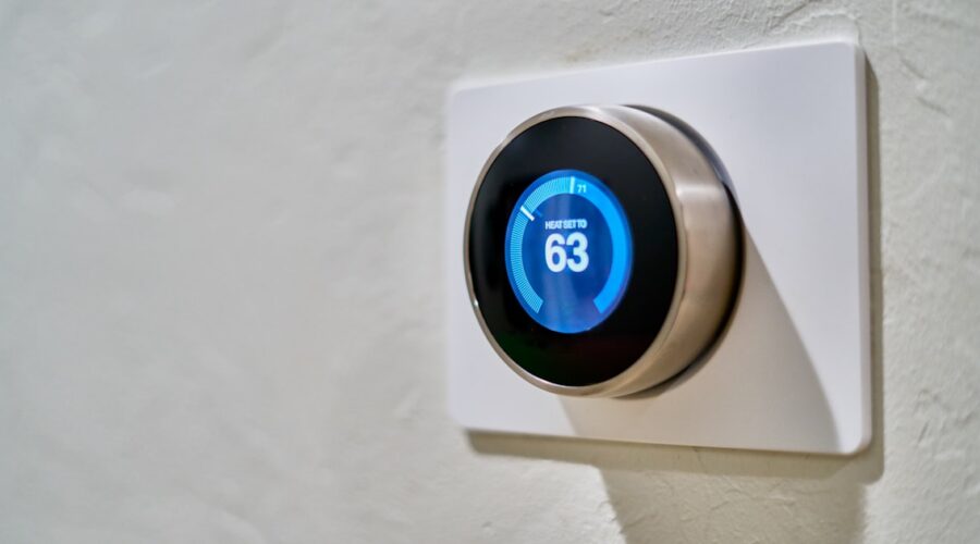 Smart thermostat on a wall showing a set temperature, the upgrade renters want without rewiring
