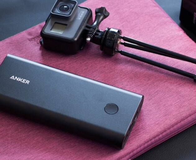Fastest charging power bank next to a portable camera, ready for travel