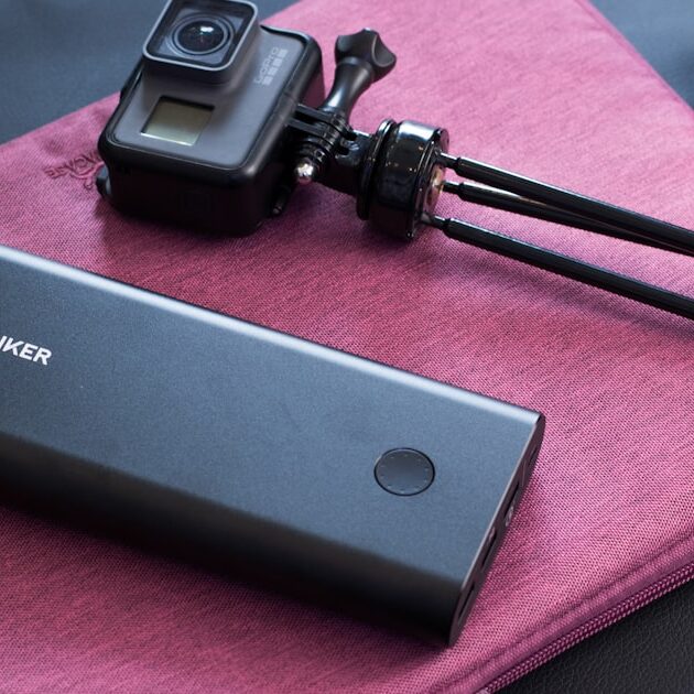 Fastest charging power bank next to a portable camera, ready for travel