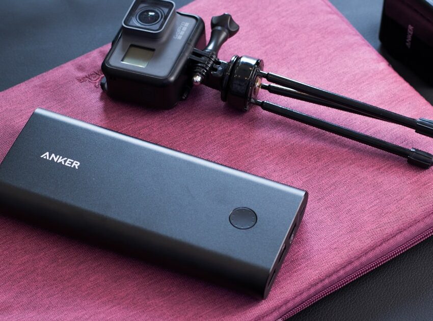 Fastest charging power bank next to a portable camera, ready for travel