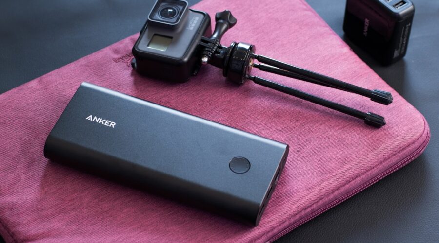 Fastest charging power bank next to a portable camera, ready for travel