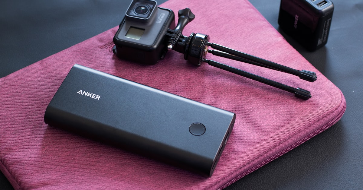 Fastest charging power bank next to a portable camera, ready for travel