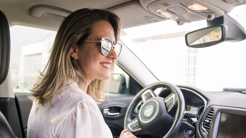 Driver seated at the wheel on a long drive, when a massage cushion should be set to its gentlest setting
