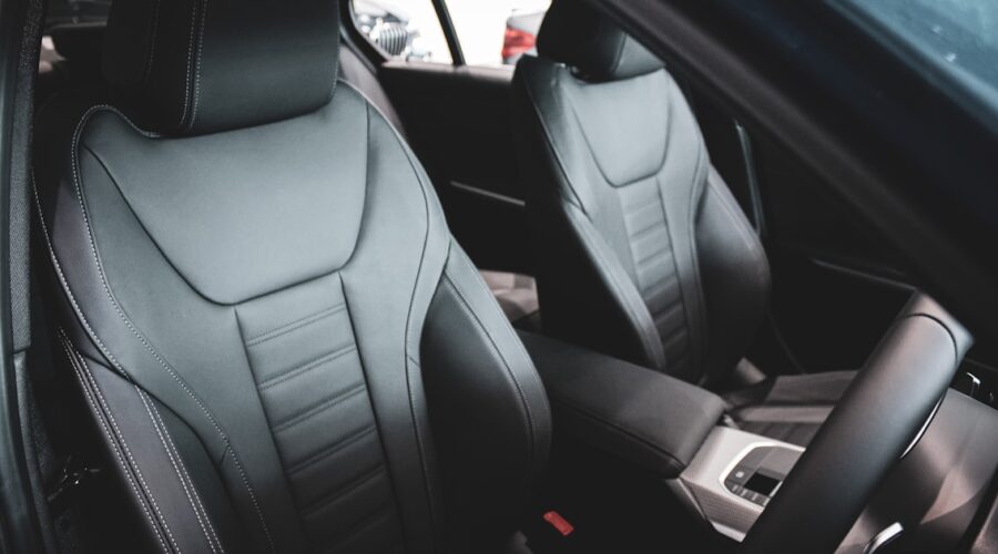 Front car seats in a vehicle interior, where a massage cushion for car seat use straps on