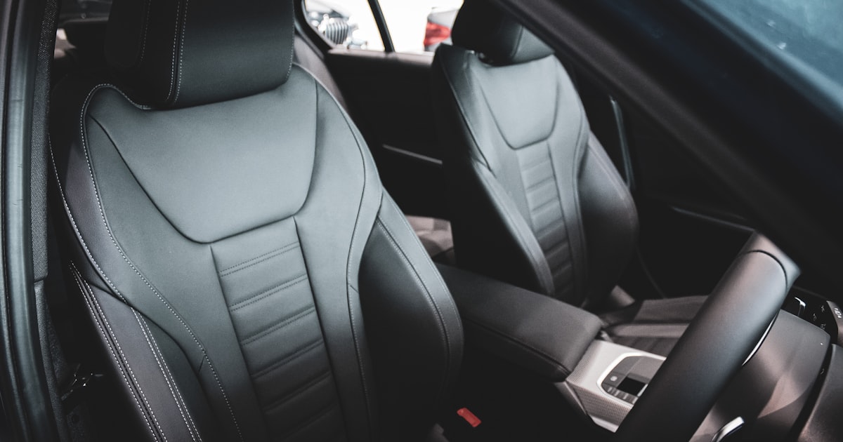 Front car seats in a vehicle interior, where a massage cushion for car seat use straps on