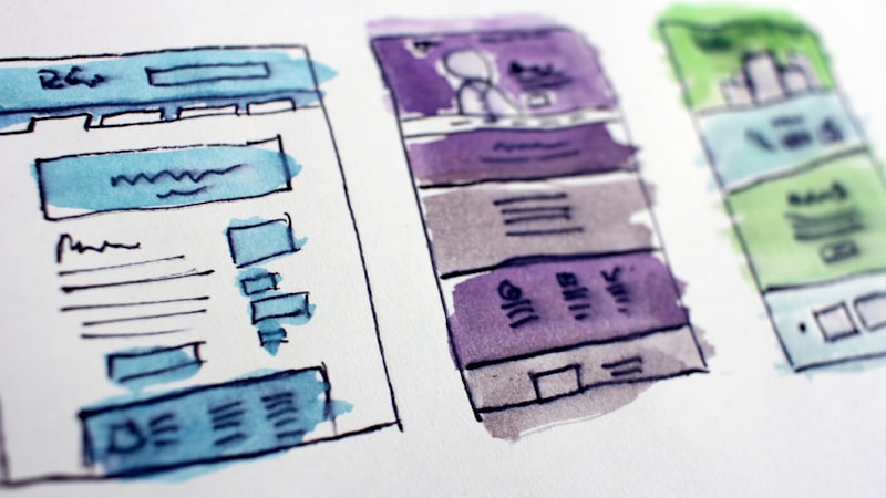 Hand-drawn wireframe sketches of page layouts, the planning step before choosing a website builder