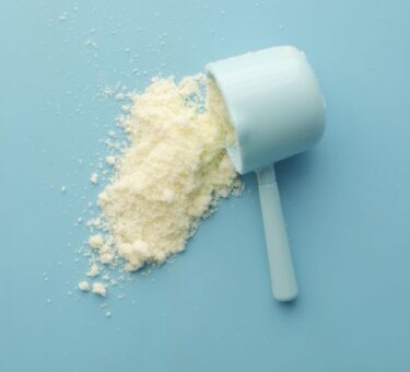 Measuring scoop tipped over with pale powder spilled beside it, the supplement side of the fiber supplement vs dietary fiber comparison