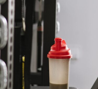 Protein shaker bottle in a gym illustrating the difference between pea protein powder and whey protein powder