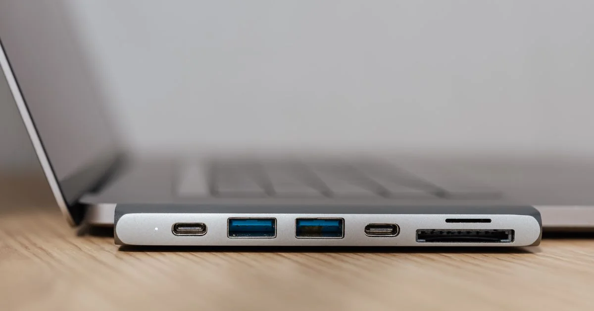 USB-C multiport hub plugged into a MacBook, one of the best MacBook accessories and gadgets for adding ports