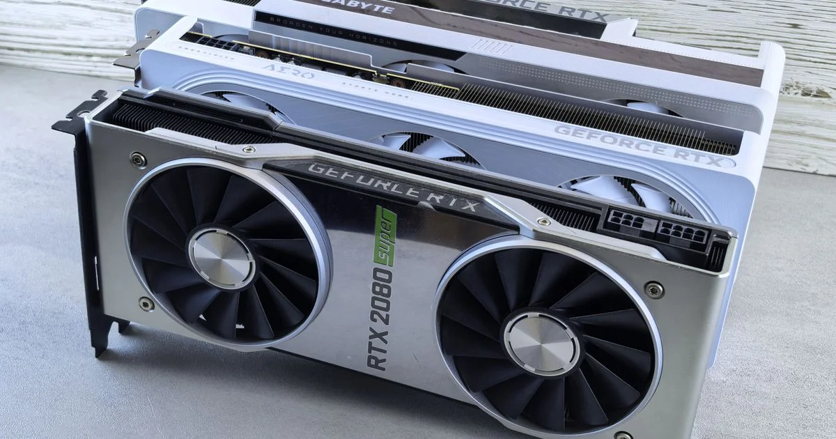 Three graphics cards laid side by side, showing the size and power connector differences between a budget graphics card for gaming PC builds and larger models