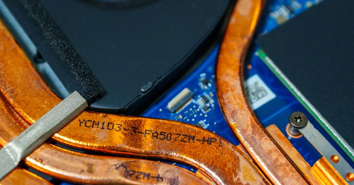 Copper heat pipes and the fan inside a gaming laptop, the cooling system a cooling pad for gaming laptop use can only assist