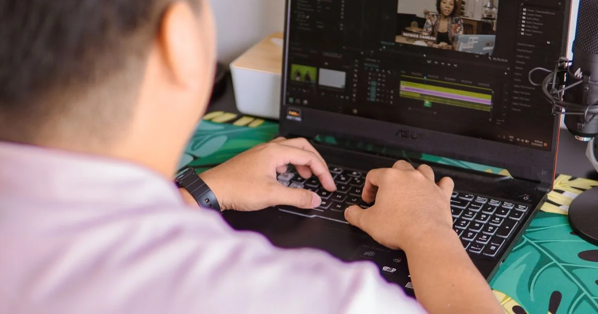 Person editing a video on an ordinary laptop, the setup most free video editing software is used on