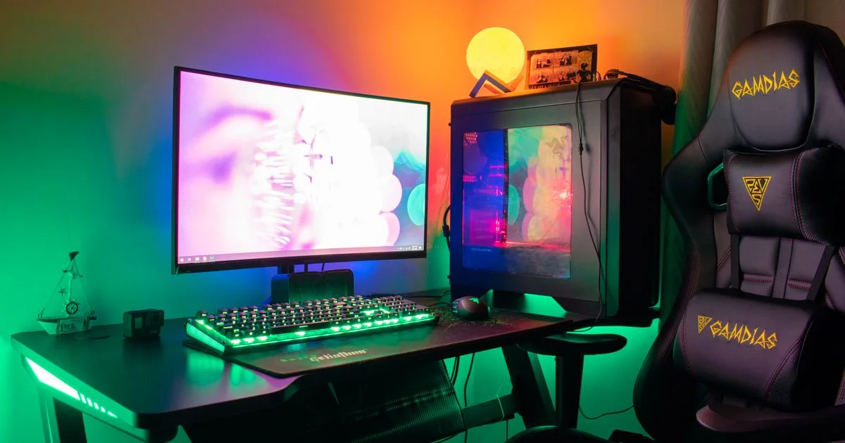 Compact gaming setup ideas for small room spaces: desk, monitor, tower PC and chair against a bedroom wall
