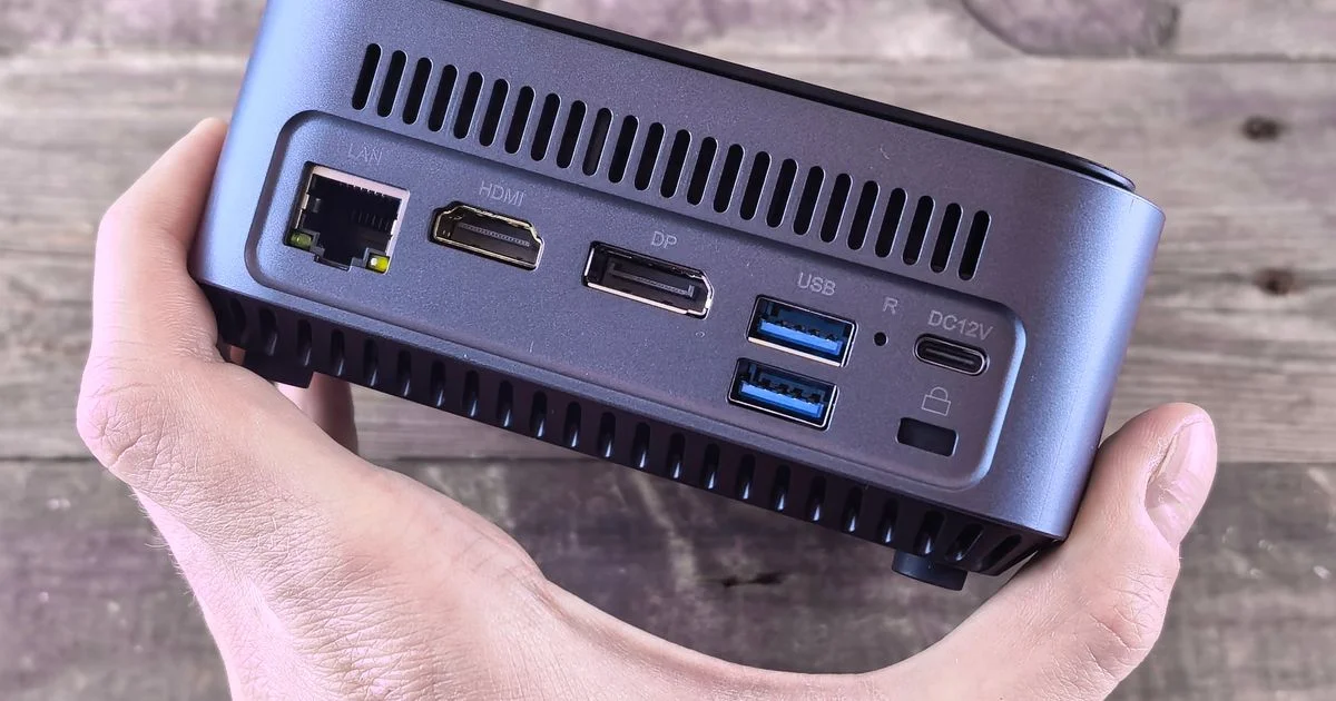 The rear panel of a mini PC showing its LAN, HDMI, DisplayPort and USB ports, the outputs that decide what a home theatre PC can drive