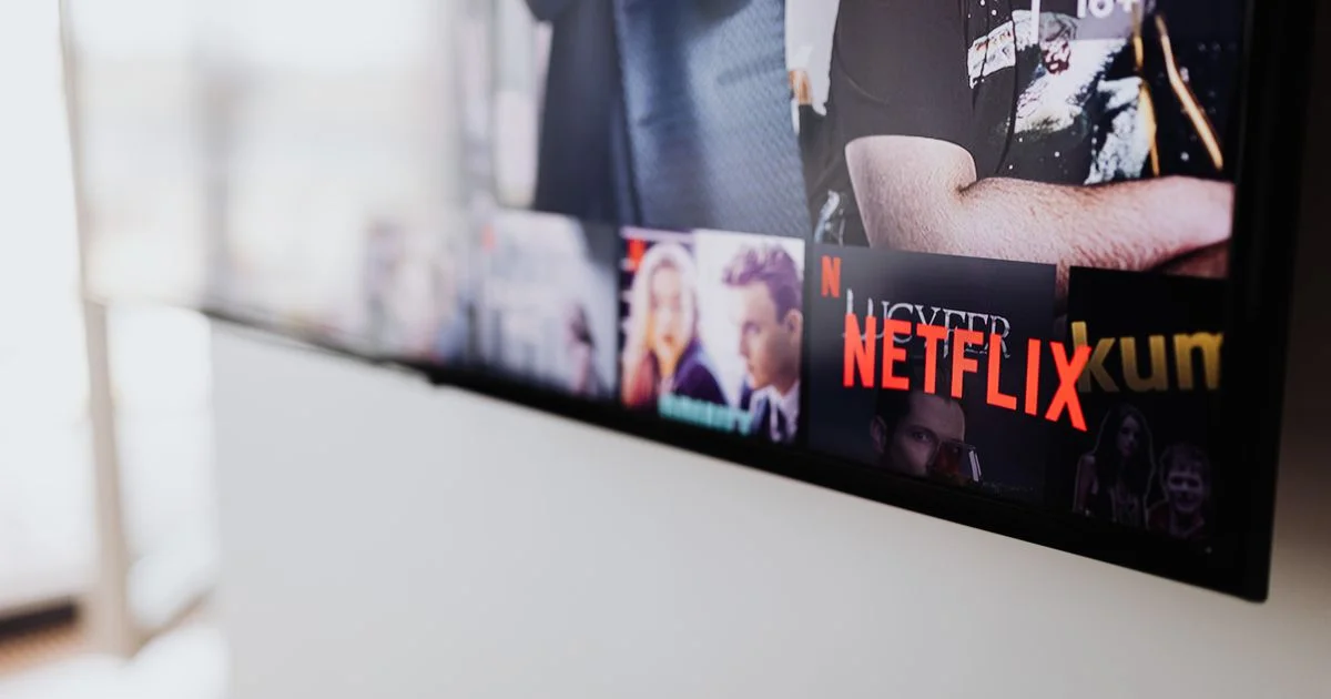 Wall-mounted screen showing a streaming menu, illustrating the LG smart TV vs Samsung smart TV picture comparison