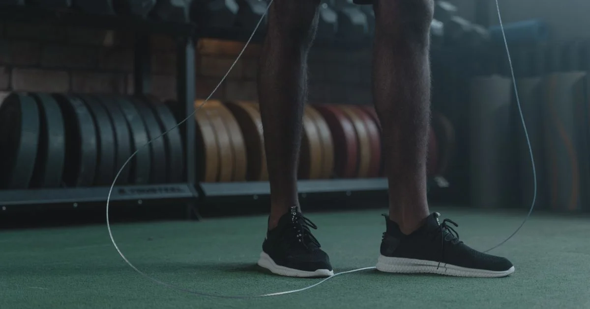 A thin speed rope cable sweeping under a jumper's feet, the revolution counted in any smart jump rope vs regular jump rope comparison
