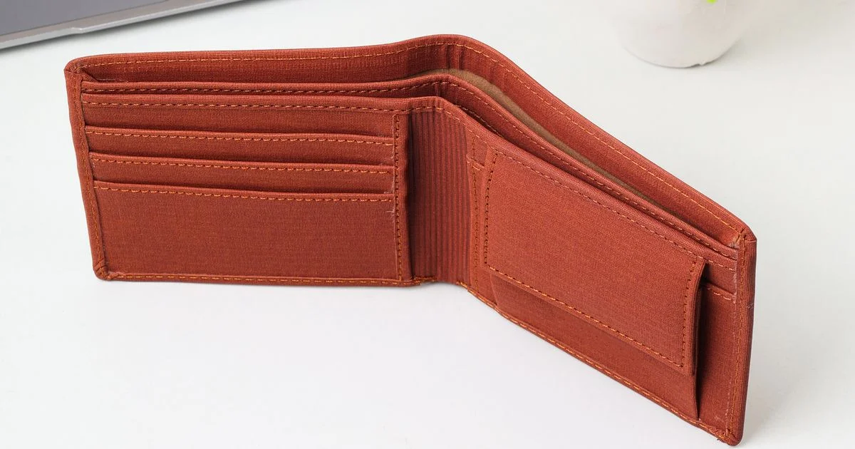 Open bifold wallet showing its card slots, the baseline in a smart wallet vs regular wallet comparison